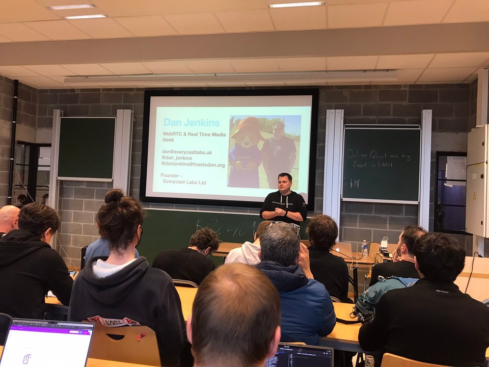 Dan up on stage at FOSDEM Open Media Dev Room